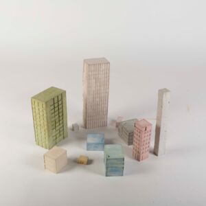 A model photo of a small colorful settlement with high-rise buildings. Various cardboard materials.