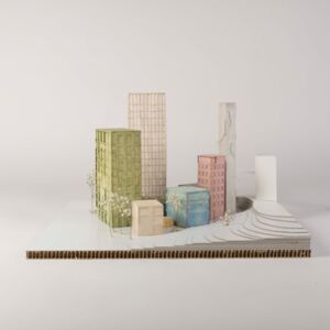 A model photo of an urban planning model of a small colorful settlement with high-rise buildings on a flat 3D terrain. Various cardboard materials.