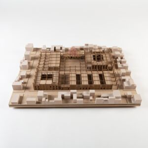 A model photo of an urban planning model of a small settlement in a flat area. MDF, wood, polyurethane.