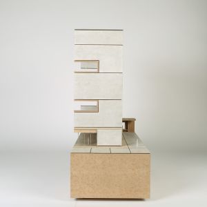 A model photo of the side view of a section model on a high pedestal. MDF, gray cardboard.