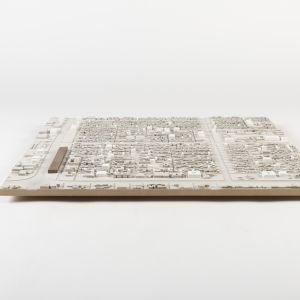 A model photo of an urban planning model of a dense city area. MDF.