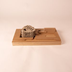 A model photo of a multi-story sunken building in its surrounding context. MDF, grayboard.